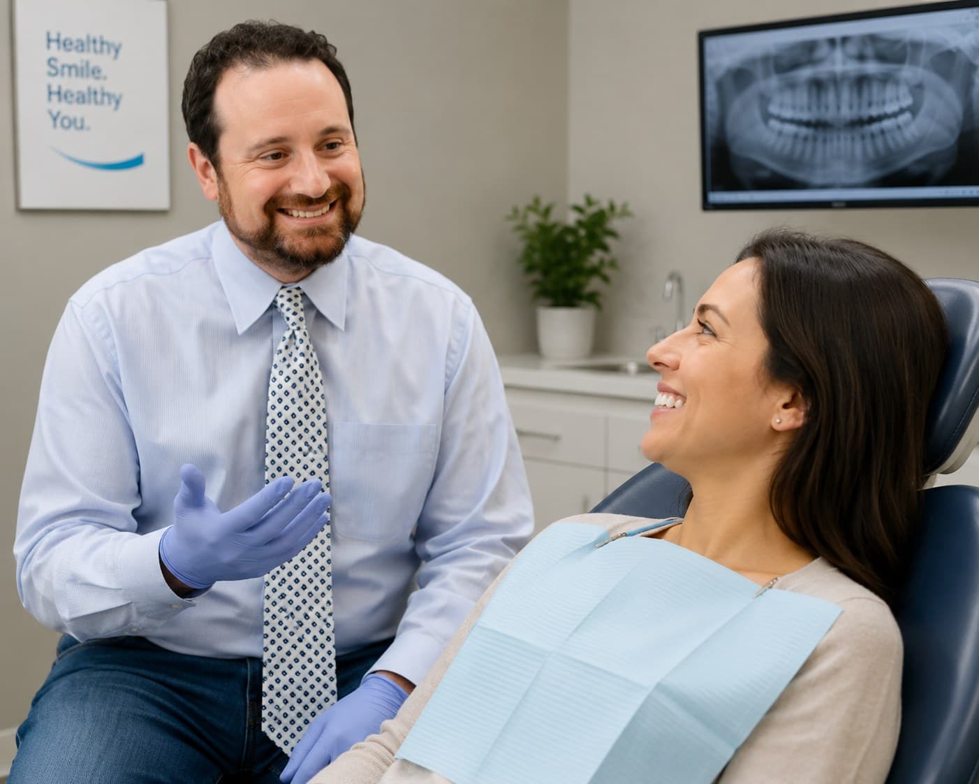 Dr. Michael Narodovich talking with a smiling patient in a treatment room at Waikiki Dental